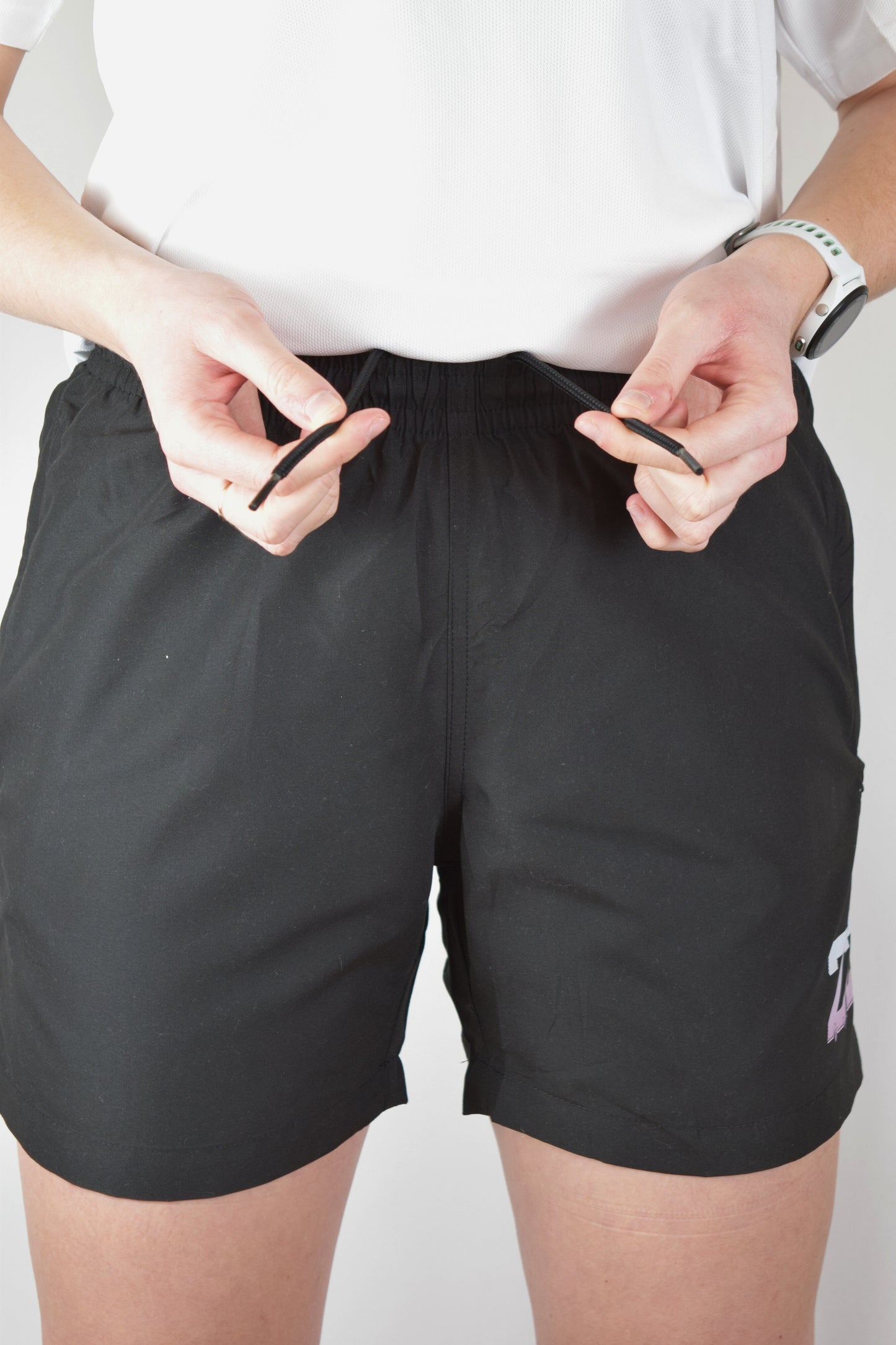 Lady wearing quick dry athletic shorts demonstrating the drawstring in the waistband