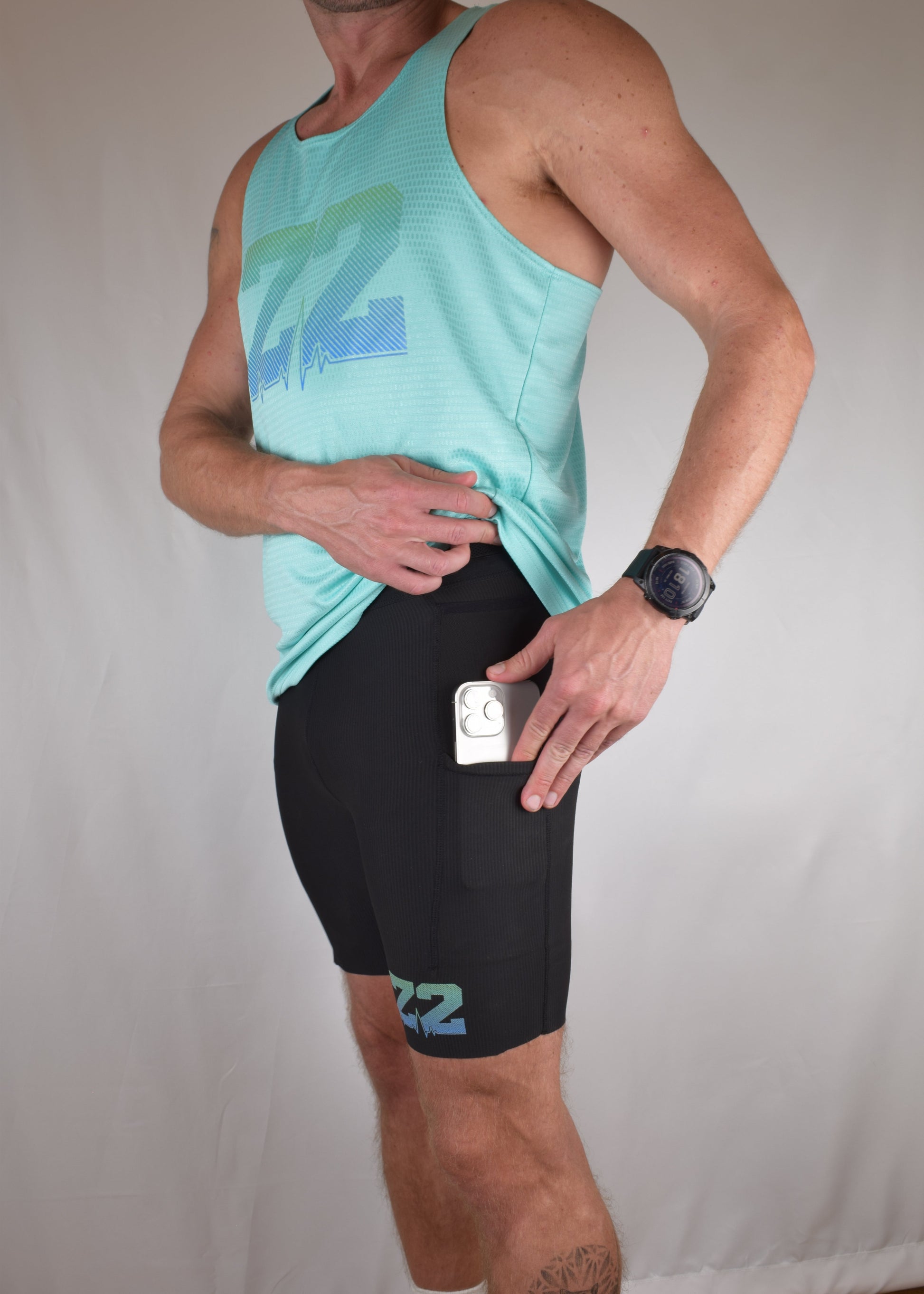The enduro tights in black with the model demonstrating the phone pocket on either side