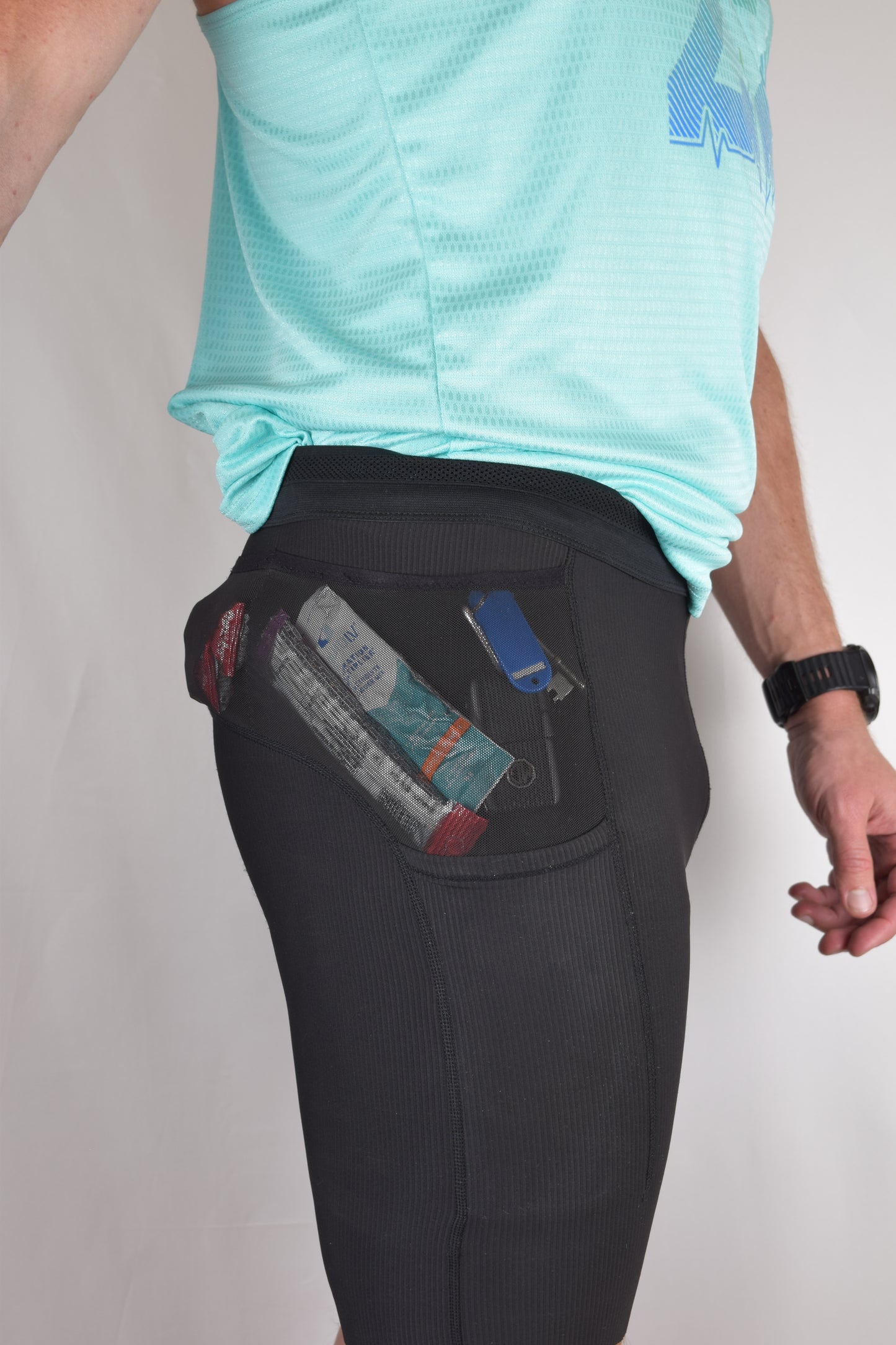 The enduro tights in black from the side demonstrating their generous side pocket capacity