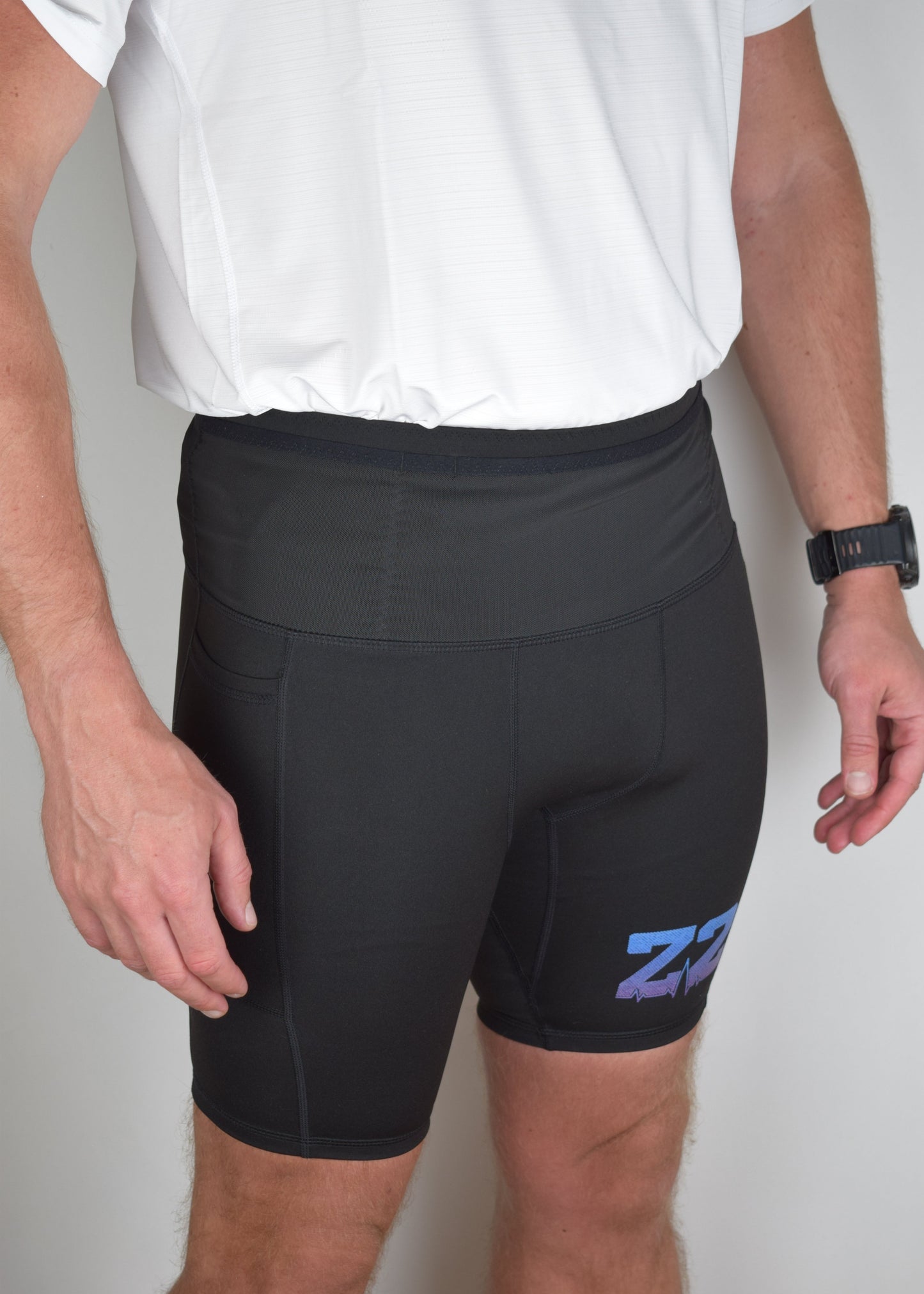 Orbit half tights in Black demonstrating their built in running belt and generous pockets.