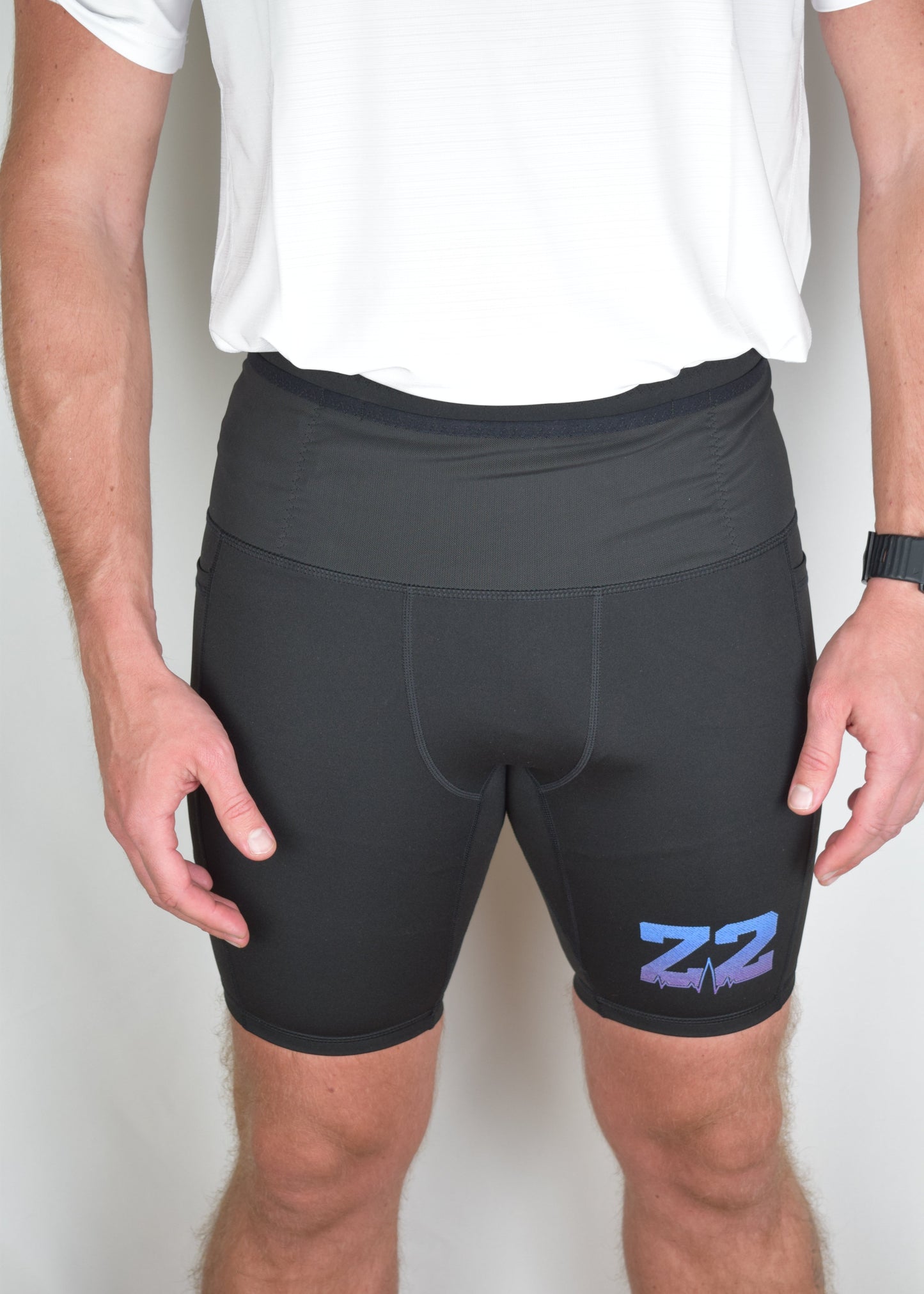 Orbit half tights in Black demonstrating their built in running belt and generous pockets.