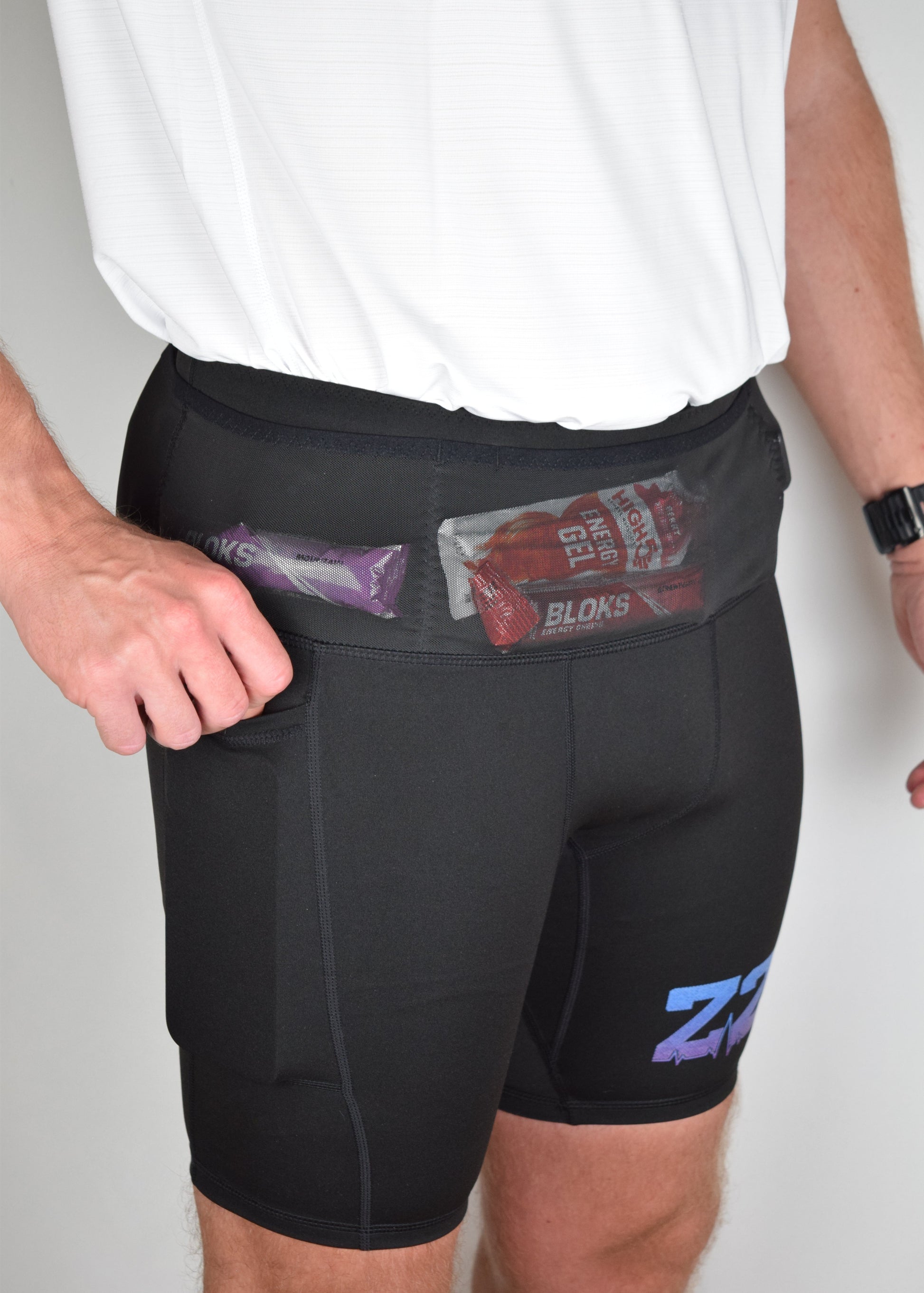 Orbit half tights in Black demonstrating their built in running belt and generous pockets.