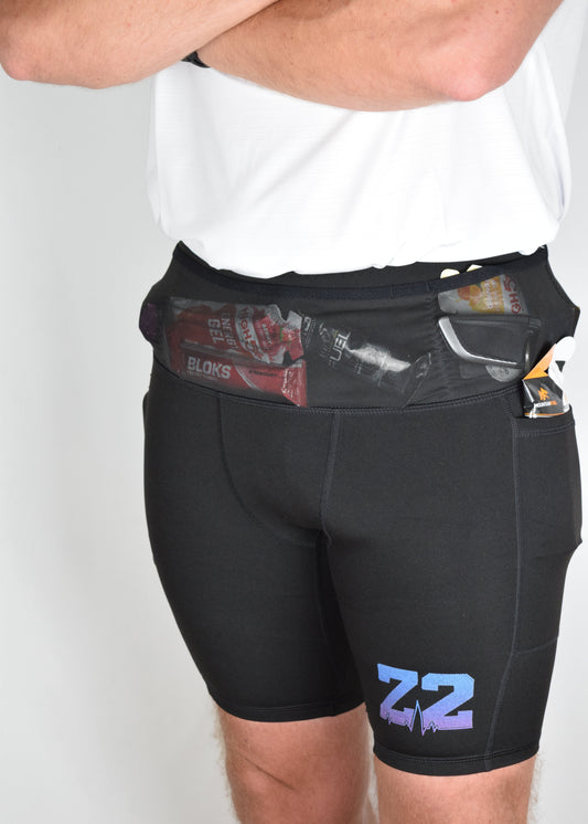 Orbit half tights in Black demonstrating their built in running belt and generous pockets.