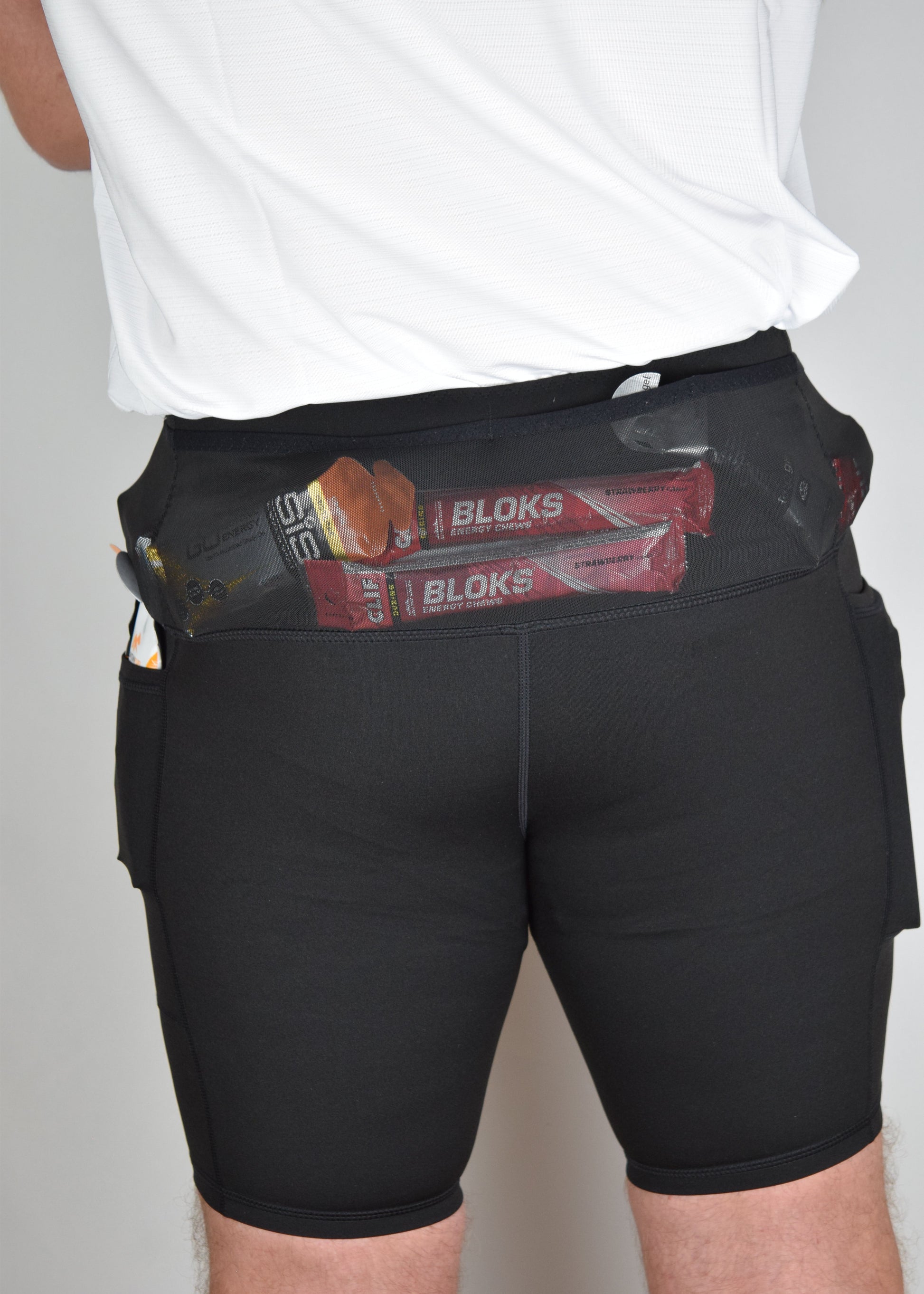 Orbit half tights in Black demonstrating their built in running belt and generous pockets from the rear.