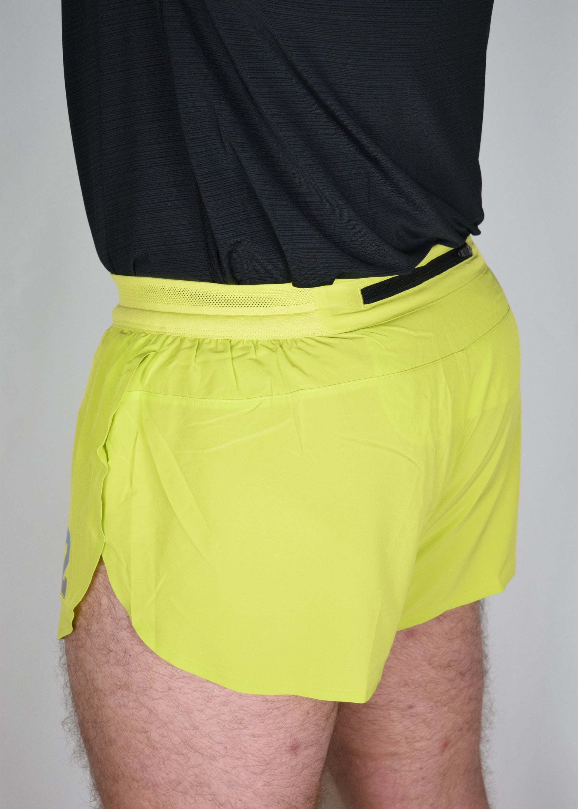 Stride 4 inch running performance shorts in yellow, facing 45 degrees away from the camera