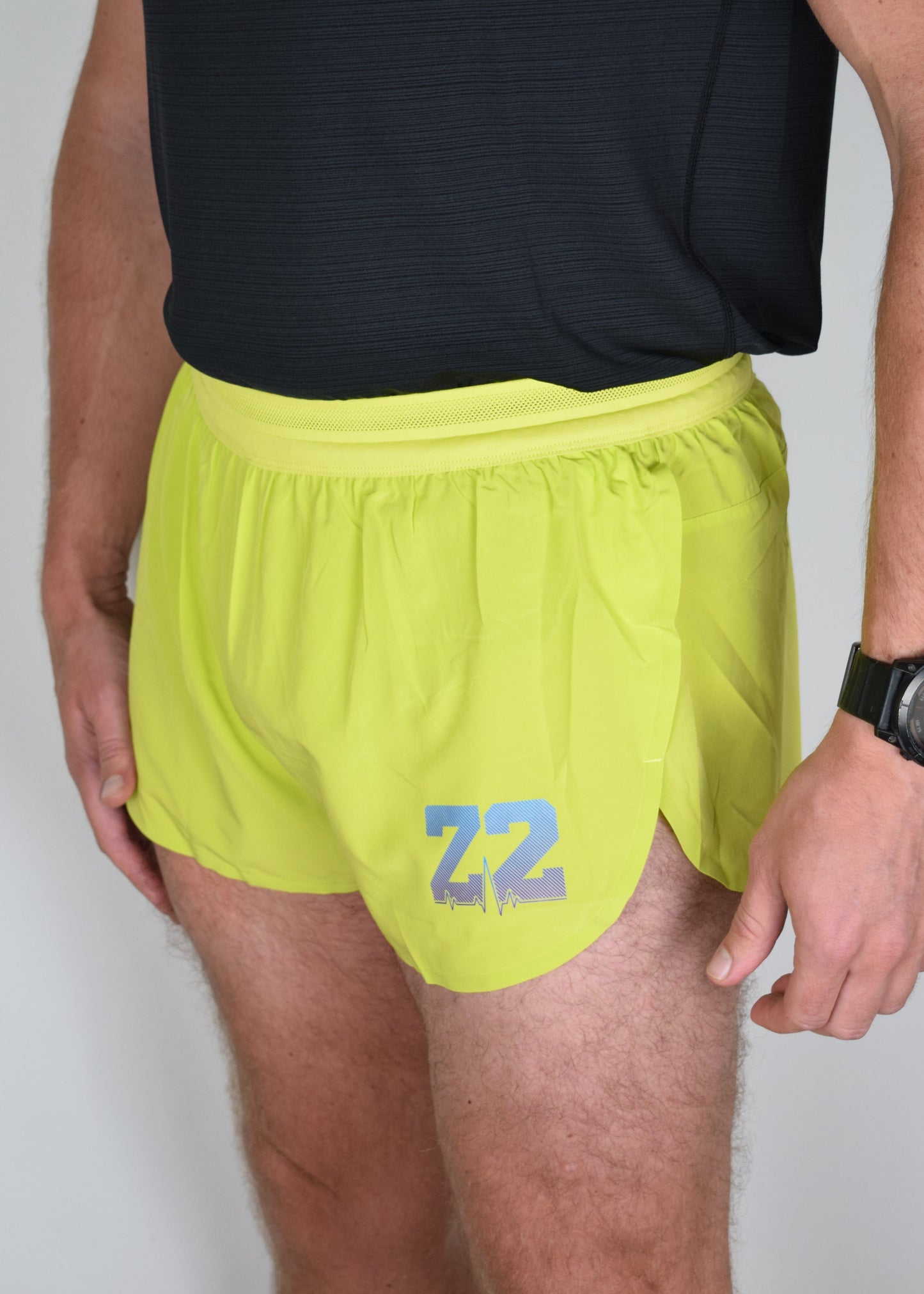 Stride 4 inch running performance shorts in yellow, facing 45 degrees