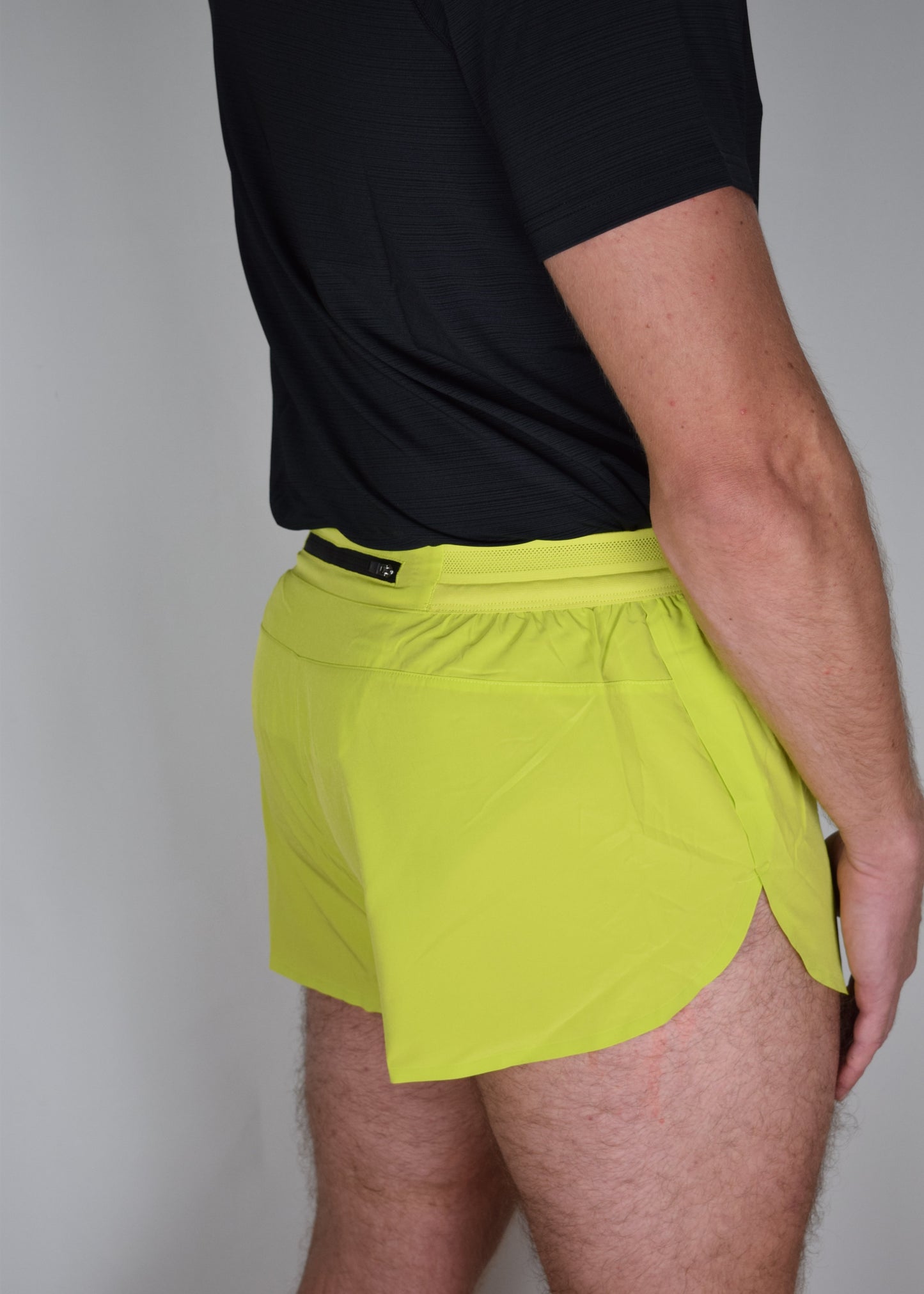 Stride 4 inch running performance shorts in yellow, facing 45 degrees away from the camera