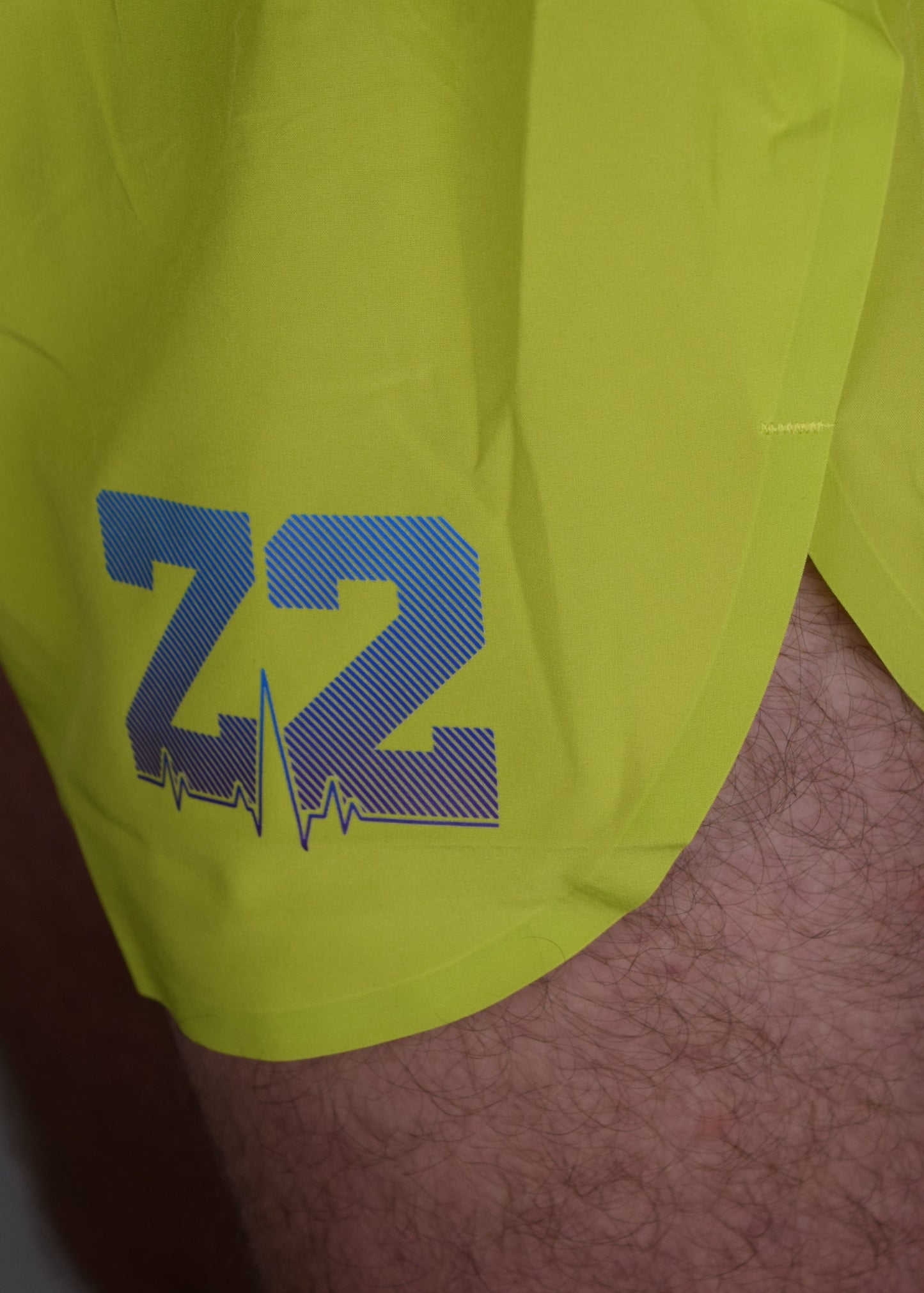Stride 4 inch running performance shorts in yellow, facing 45 degrees focussing on the Z2 Apparel logo