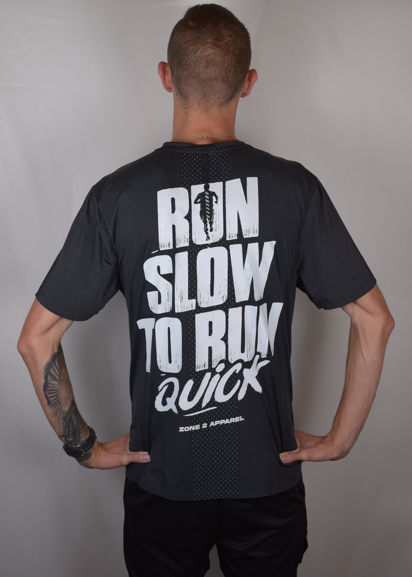 The Mantra Technical Running Tee in black from the back with Run Slow To Run Quick displayed