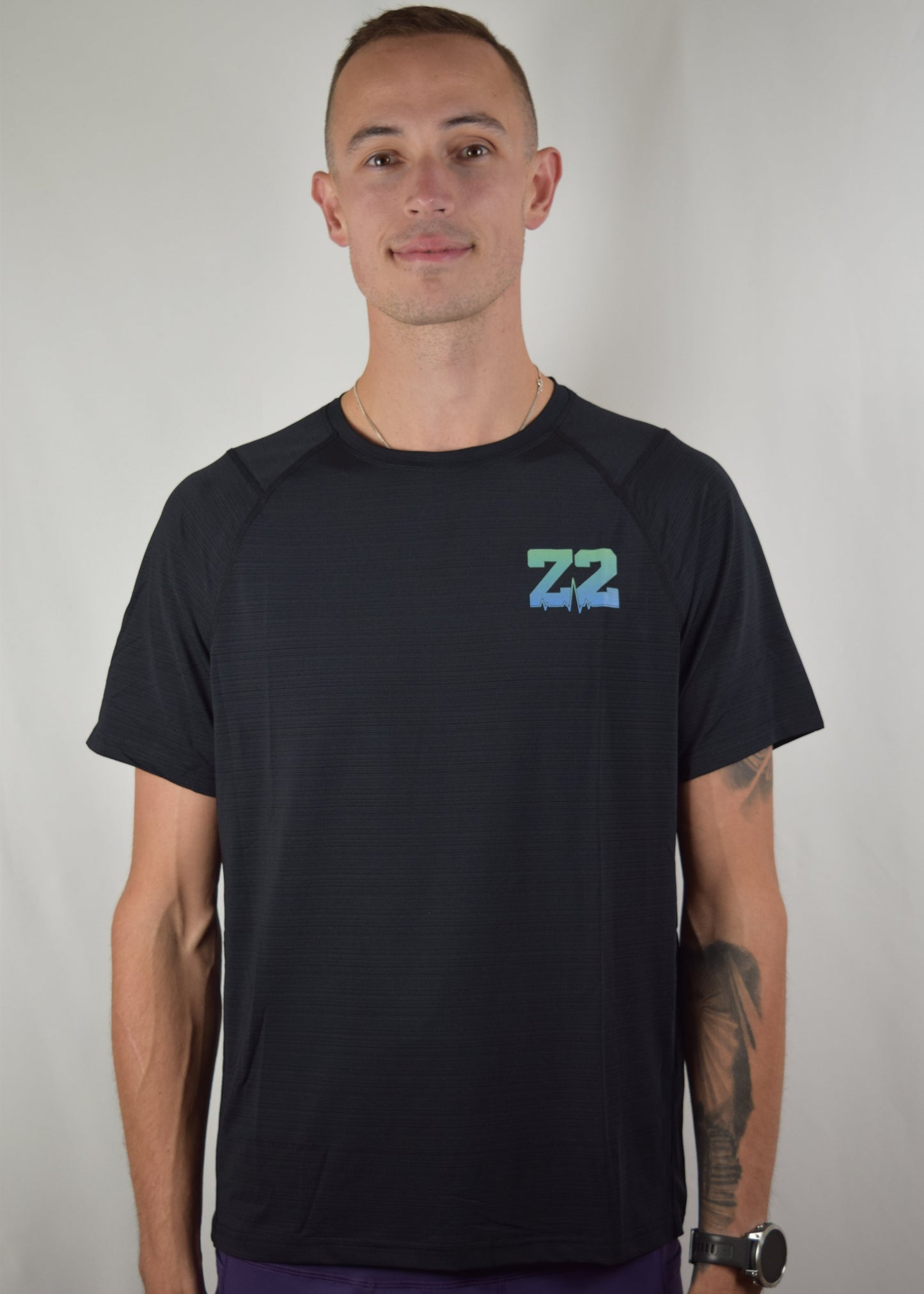 The Mantra Technical Running tee shirt in black from the front.