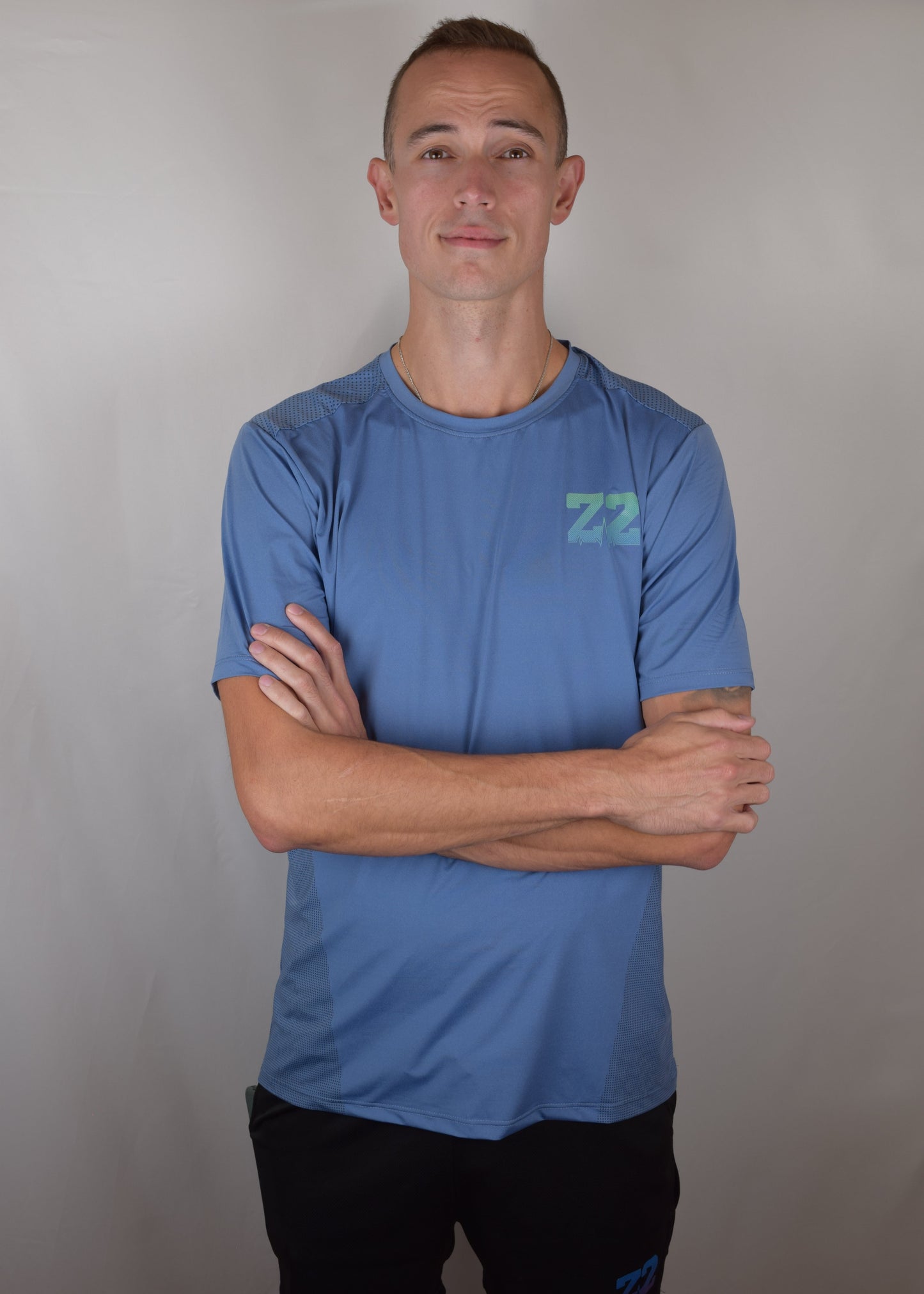 The Split Tee Technical Running T-Shirt in blue from the front, with a green logo